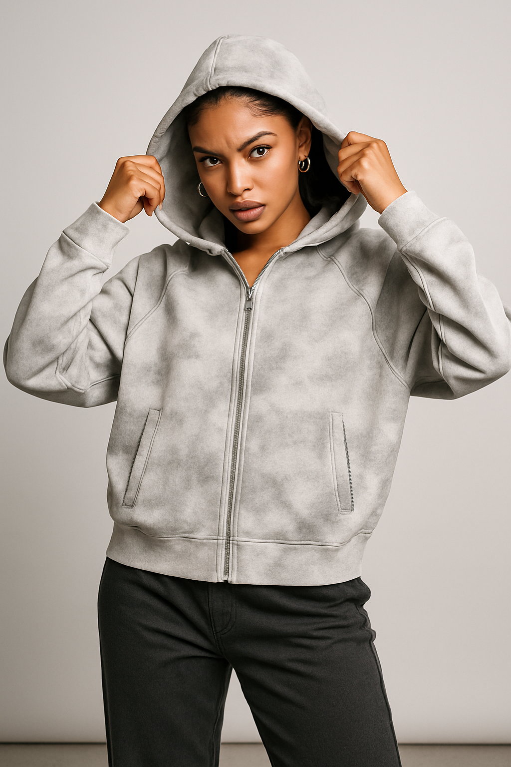 Person wearing a gray hoodie against a plain background