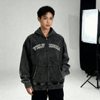 Person wearing a black hoodie with 'VELVENCIA' branding in a studio setting.