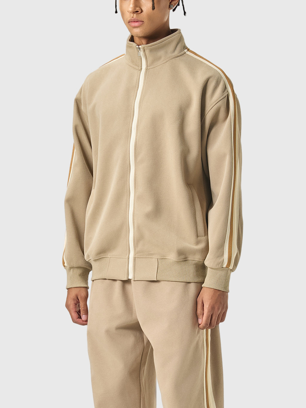 Beige tracksuit with white stripes on a white background