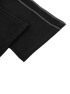 Close-up of black fabric with a white background
